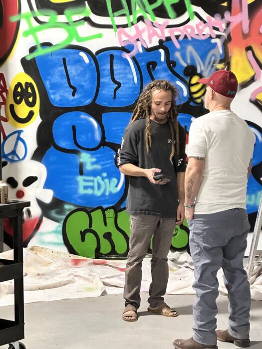 The graffiti artists with Life Shop staff in front of their work