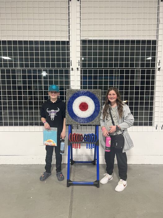 Two teens with their certificates after the axe-throwing competition
