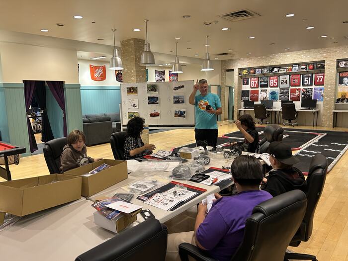 A wide view of the build class with teens at every seat