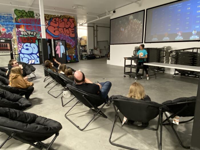 Teens in camp chairs watching the big screens