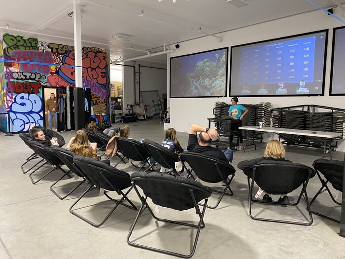 A wide view of a class running, teens in moon chairs and the screens up