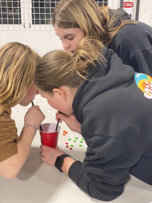 Teens working on diamond art at the tables