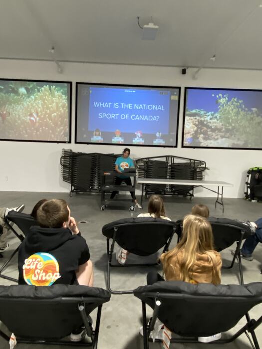 A staff member running a class quiz on the big screens