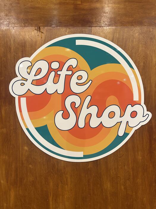 The Life Shop logo on the wood wall