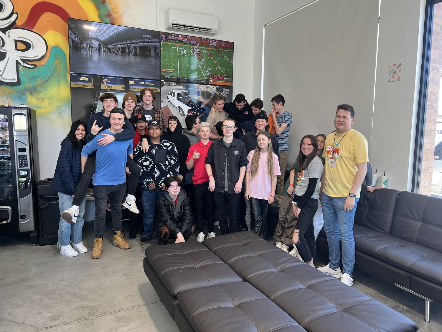 A room full of teens and staff in the Life Shop lounge