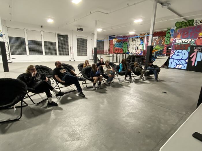 Teens watching a film from the moon chairs
