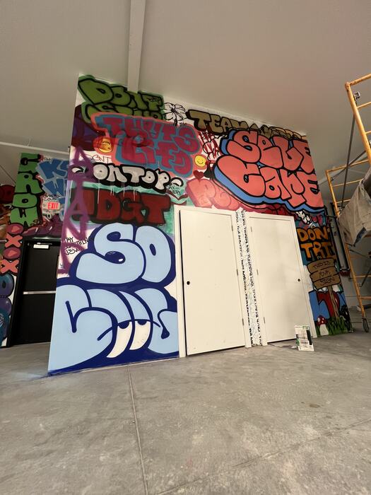 Graffiti-painted panels standing in the main room