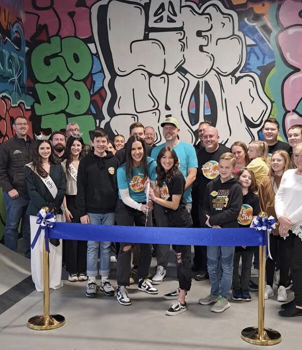 The Life Shop ribbon cutting with a crowd of teens, families and city guests