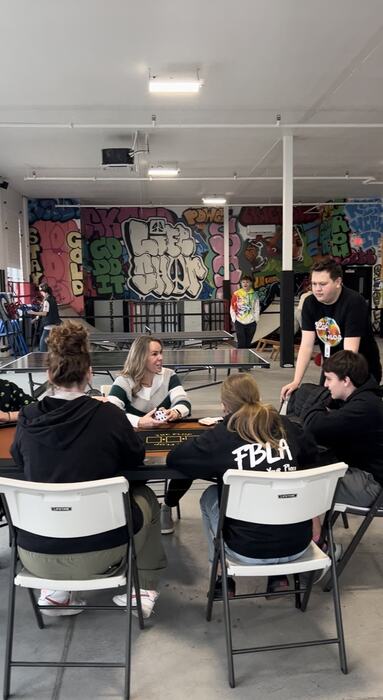 Teens and staff around the poker table