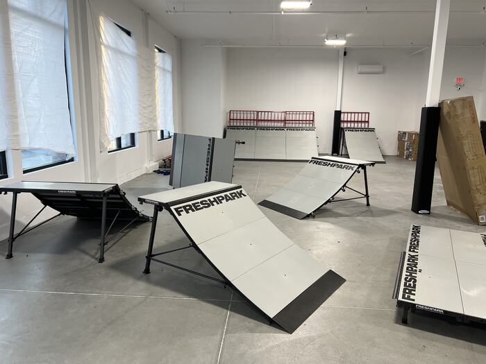 The first ramps standing in the empty room, sheets still over the windows