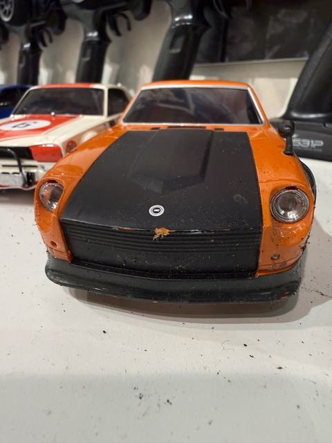 An orange Datsun 240Z RC car