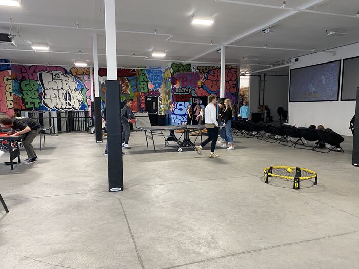 A wide view of the Life Shop floor with games running