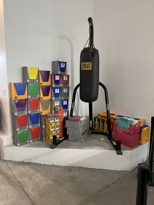 Stacked boxes of donated school supplies inside Life Shop