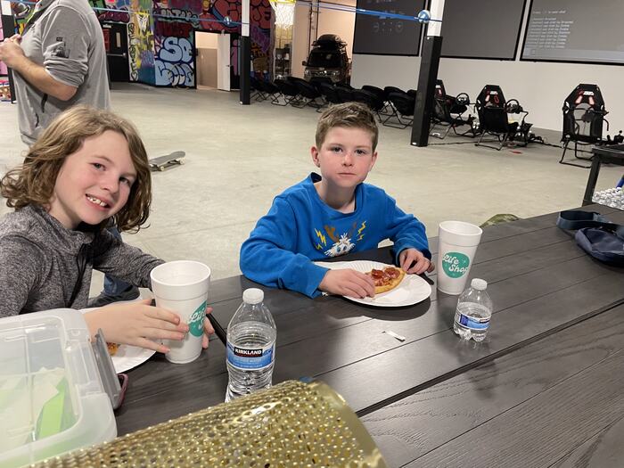 Teens with drinks and snacks at the table