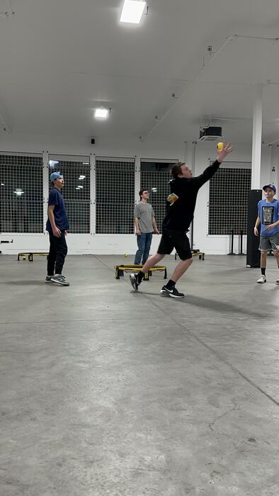 Teens playing Spikeball in the main room