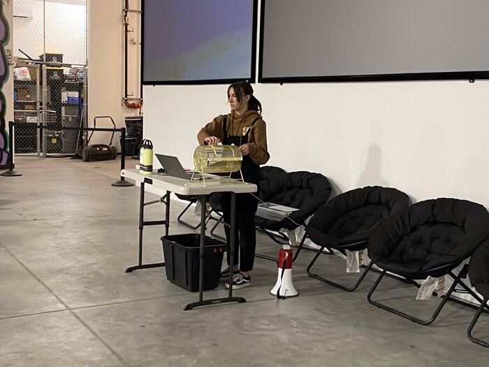 A Life Shop staff member setting up at the front, moon chairs laid out for the group