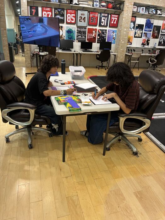 Teens working at a table in the main room