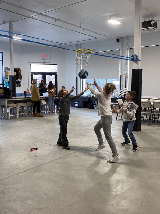 A volleyball game in full swing across the main room