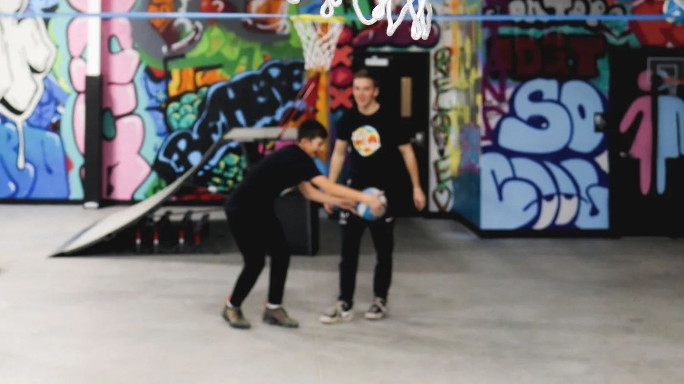 The indoor skate park at Life Shop with graffiti murals behind it